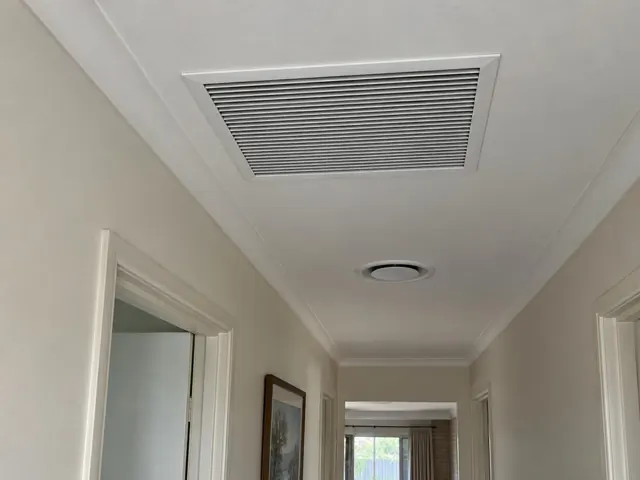 Hallway ceiling return-air grille in a modern home interior in Golden Grove